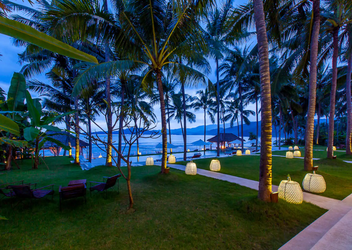 Garden and pool beside the beach at dusk