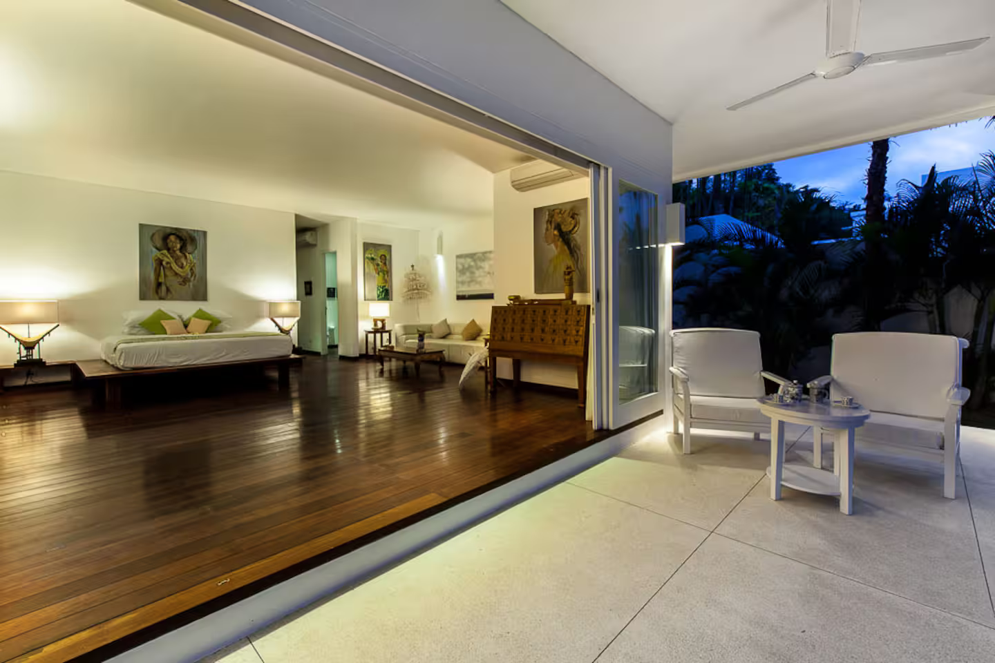 Open-plan living and dining area illuminated at dusk