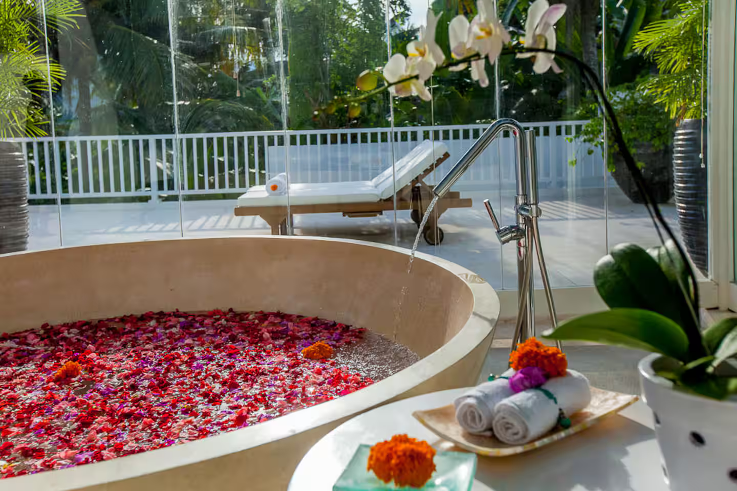 Flower-filled round bathtub overlooking the garden