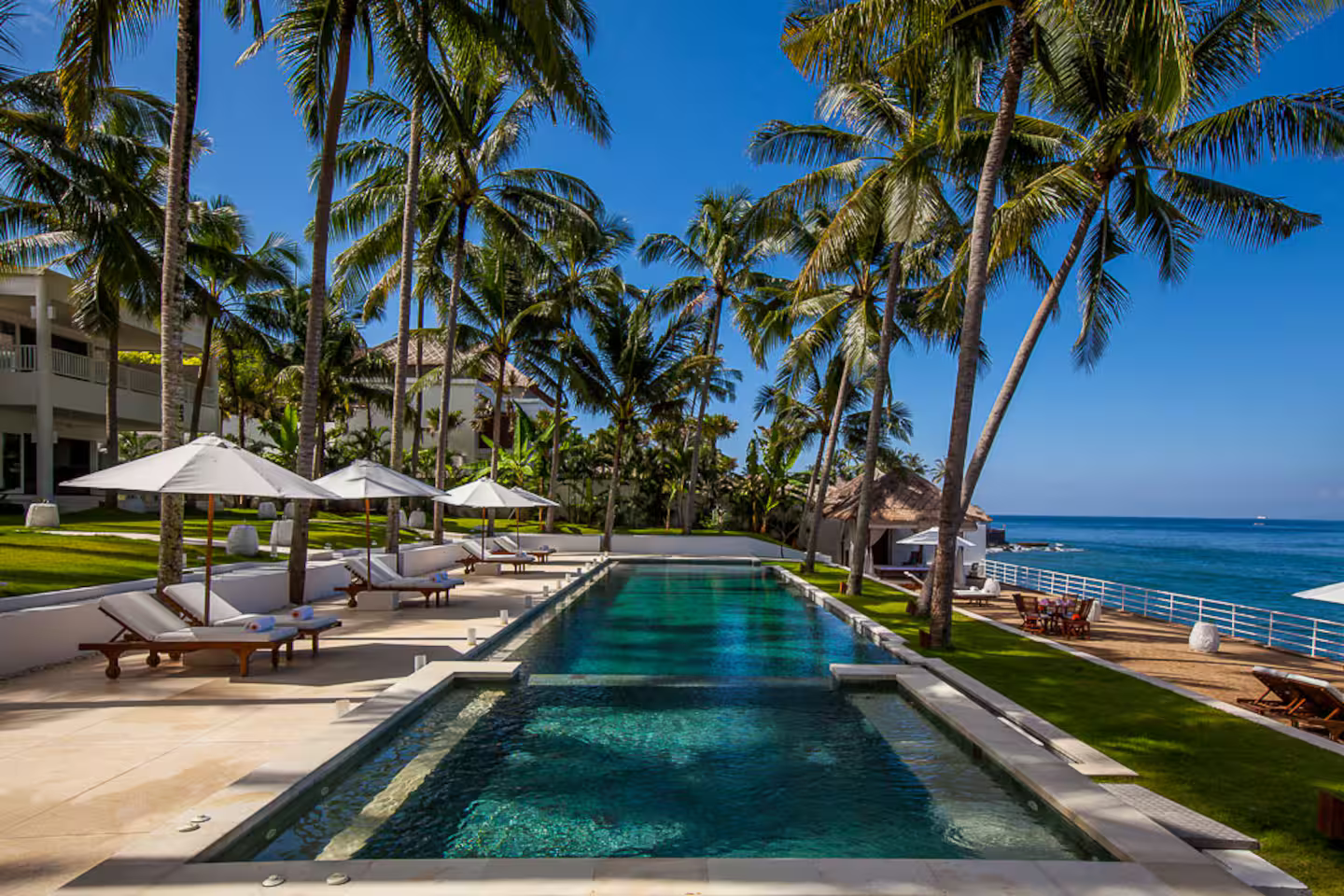 Swimming pool with loungers beside the sea