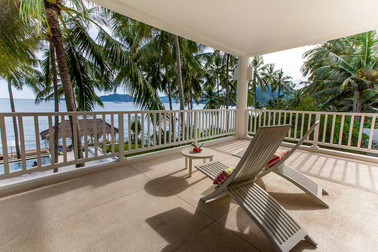 Outdoor terrace with seating and palm trees
