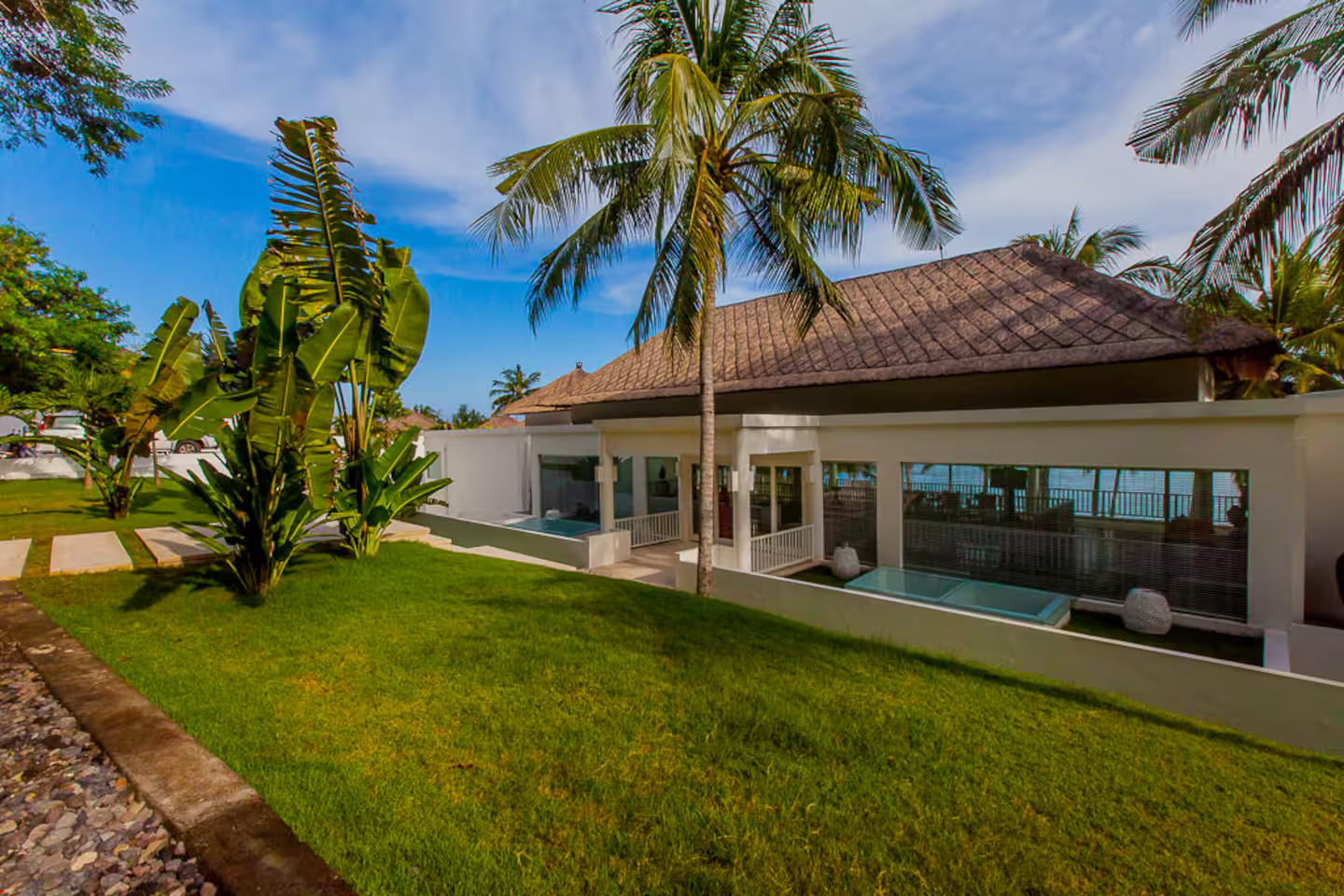 Villa Lucia framed by tropical gardens and blue sky