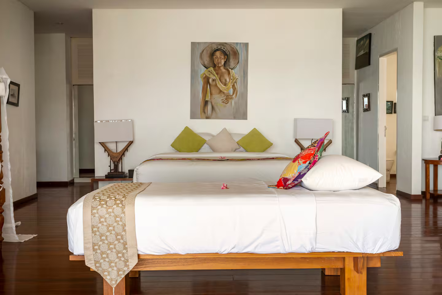 Bedroom with a four-poster bed and colourful artwork