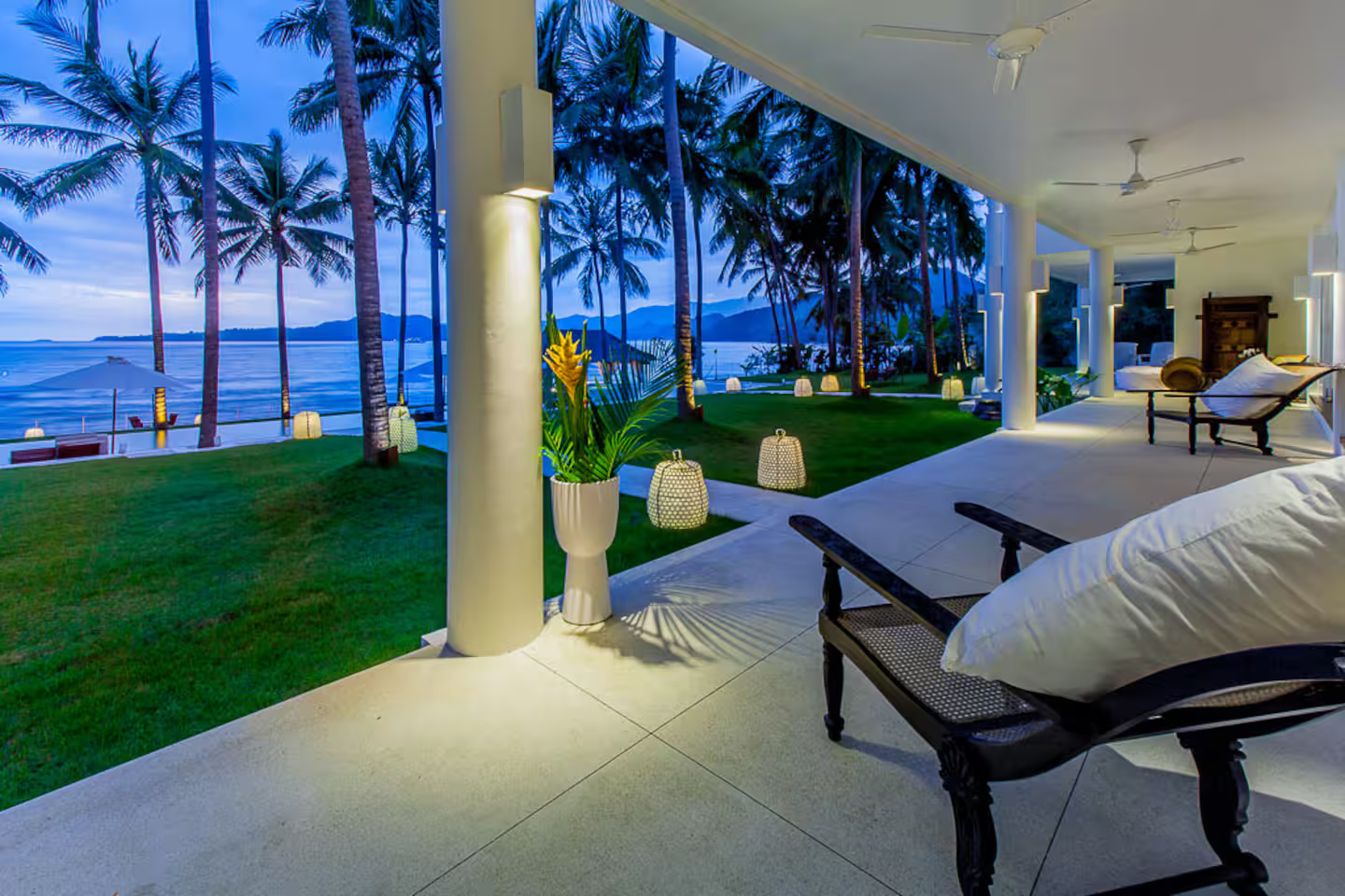 Poolside loungers overlooking the garden at dusk