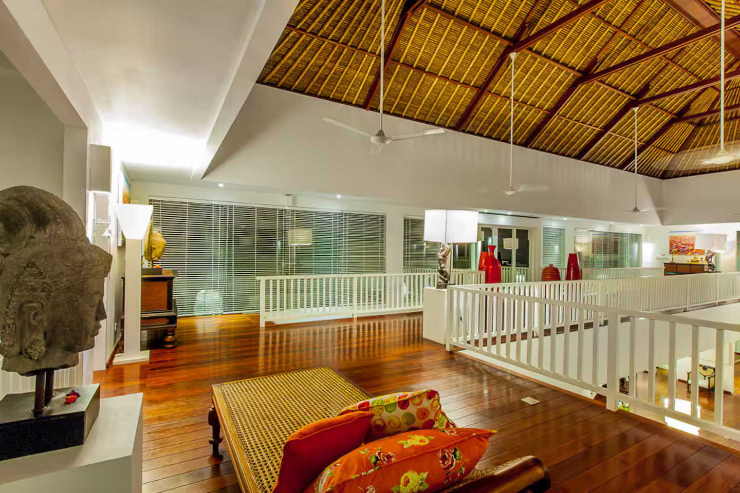 Indoor balcony beneath a high thatched ceiling