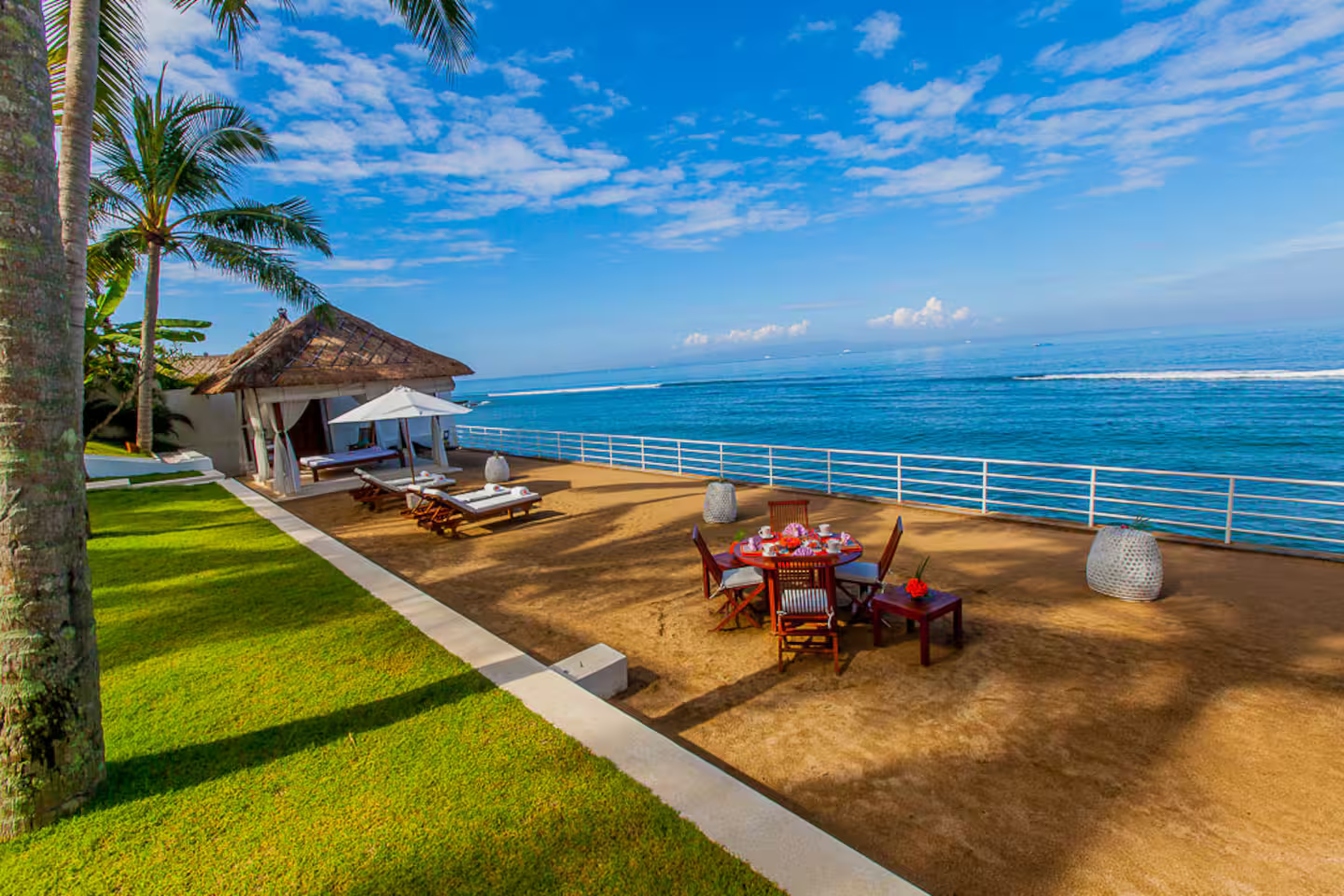 Beachfront seating and sun loungers overlooking the bay