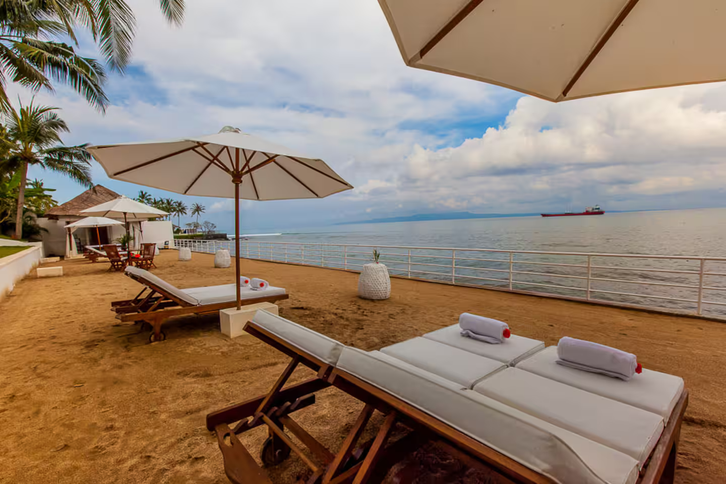 Sun loungers and parasols overlooking the shoreline