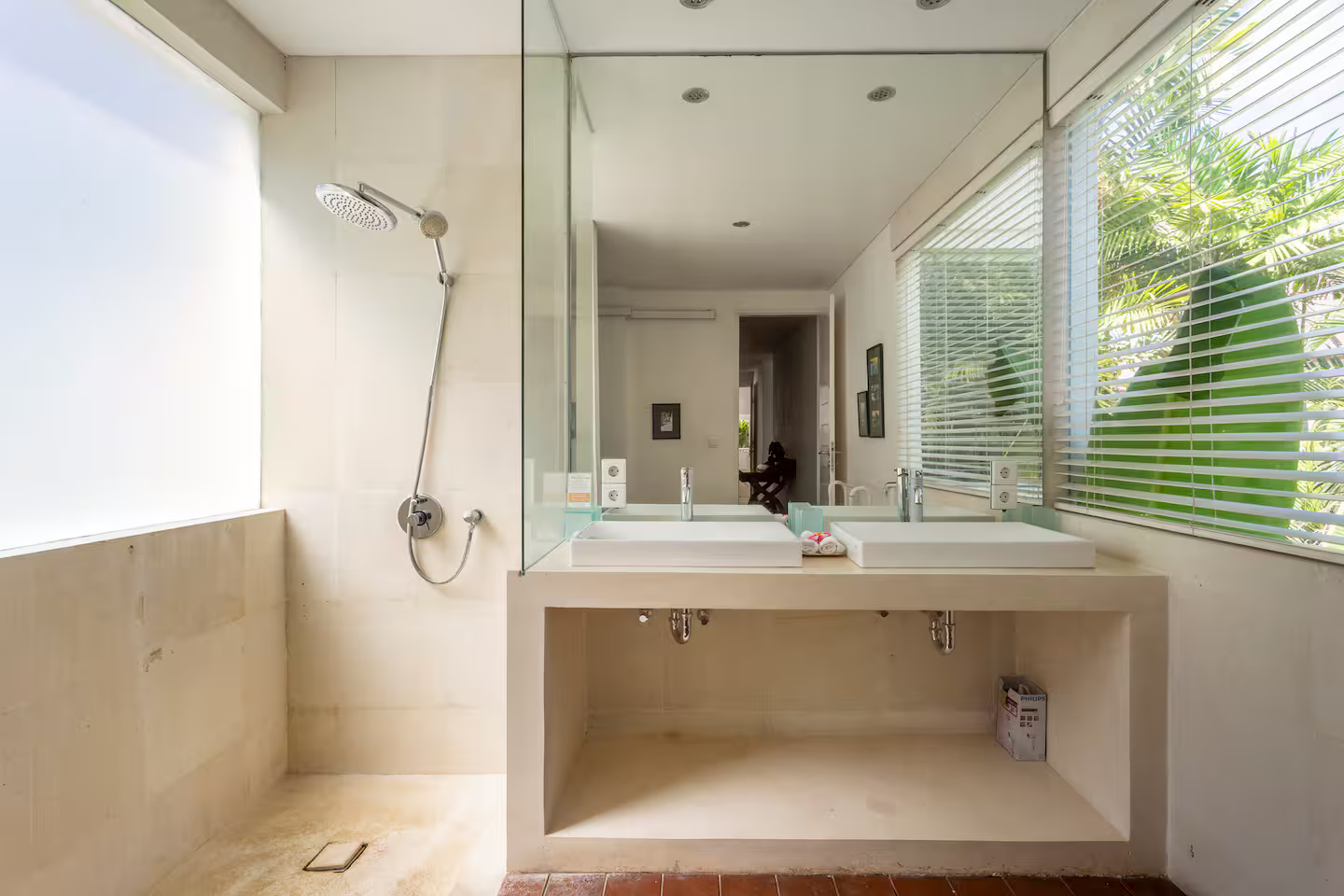 Bathroom vanity with a large mirror and garden views